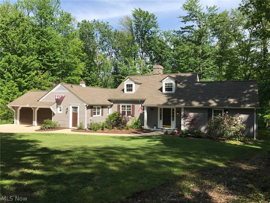 Looking for your own personal nature preserve of perfect serenity just minutes from Chagrin Falls Village and much more?  Your own 20+ acre parcel of heaven full wooded acreage including Chagrin River waterfront is part of the protected Chagrin River Land Conservancy. The home, tastefully remodeled by the owners mainly in 2012, maintains the Cape Cod charm of the original build with some modern amenities!  The great room addition with beamed cathedral ceiling is perfect for movie night or party night!   The kitchen with granite counter-tops, birch cabinetry, stainless appliances, Mosaic glass back splash and porcelain floor tile is a gourmet's delight!  Entertain in the formal living room with stone faced wood burning fireplace, crown molding, built-in shelving, hardwood floors, carpet inlay and French door to rear patio overlooking rear grounds.  First floor master with spacious walk-in closet and adjacent remodeled full bathroom.  Three BRs upstairs plus updated full bath.  Other maj