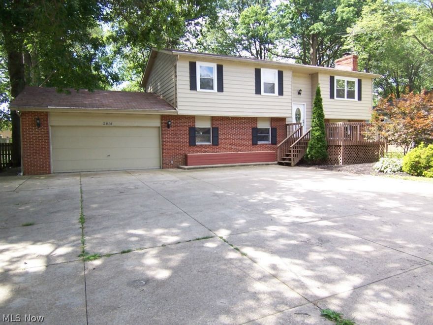 Tons of space in this large bi-level! 4 bedrooms and 2.5 baths. The large lower level offers room for a large family area, kids play room, or theater/ entertainment room.  The deck off the kitchen over looks the large, completely fenced in back yard. This home is close to Woodland elementary school and the YMCA fields and skate park.