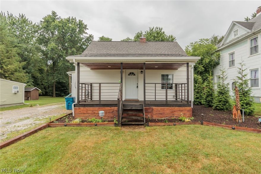 A charming Hartville bungalow with a dream back yard.  This lovely home features a custom kitchen with quarter sawn white oak countertop, shaker style soft close cabinets, a whitehaus sink, and wonderful ceramic floor.  The oversized bathroom with blow you away.  Of then many characteristics of this home, the stairs are a live edge cherry, with a handrail made of finger joined black walnut, which is also a few of the doors.  The open living room has a built in entertainment center made of ambrosia maple wrapped in tongue and groove knotty pine.  There is a front porch is made of 2" eastern red cedar, as are the Pavilion and Pergola.  The yard is completely fenced.  A full basement, garage, and so much more.
