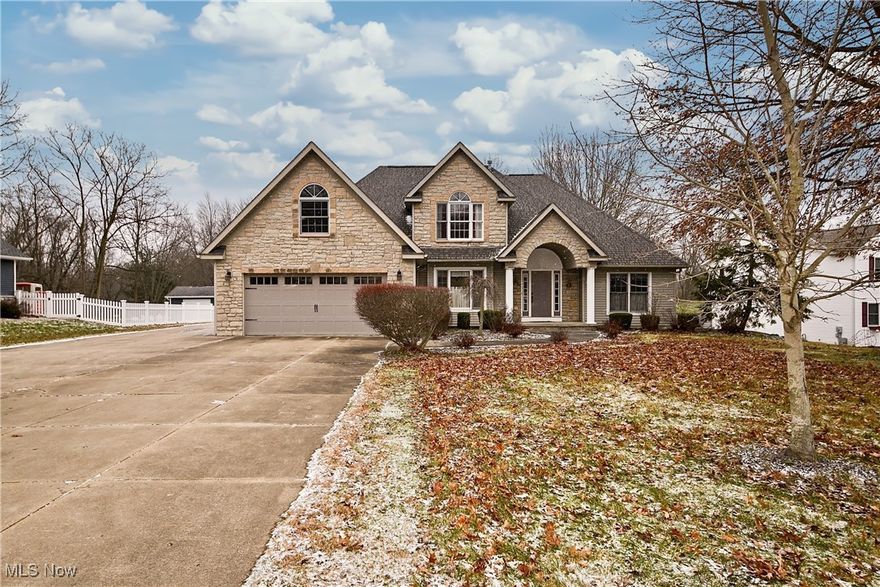 Welcome to 4887 Fireside Dr; a spacious and well maintained home in the Green LSD! Located just a stone's throw from Nimisila Reservoir, this home is situated on over an acre and has over 2800sqft of living space, giving you ample room to spread out, both inside and out. Stepping inside, you'll find a spacious kitchen with granite countertops and a large island with seating, a great room with a vaulted cathedral ceiling and stone fireplace, first floor primary suite with walk-in closet and a large soaking tub, formal dinning room, half bath, first floor laundry, and walk-up attic access which offers tons of extra storage (or could be finished and turned into additional living space). Upstairs you'll find two large bedrooms and a second full bath. The partially finished basement offers a large flex-space for whatever you need (theater, playroom, secondary living room, etc), as well as a bonus room which could be used as an office, or a fourth bedroom. The french doors in the kitchen lead you out to a large deck and sizable patio with a fire pit that overlooks the back yard. The additional detached two-car garage has a gas heather, water, electric and a workshop. Furnace and AC were replaced in 2022. You don't want to miss this one, so call your favorite agent for a private showing!