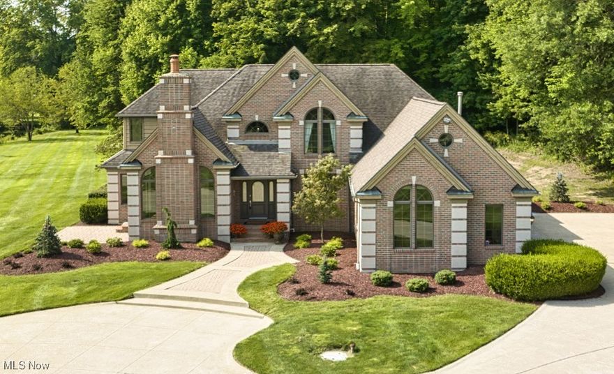 Welcome home to one of Portage County’s finest! Luxurious custom-built private estate is a perfect mix of country living and modern sophistication. First impressions are everything, and this home exceeds all expectations. Breathtaking views on this spectacular 4.5+ ac property exude tranquility & serenity. Custom details and updates make this a one-of-a-kind home. With 4 BRs and 3.5 BAs, you’ll have ample space to relax & unwind. The open floorplan is perfect for entertaining. The 2-story foyer makes a grand statement and leads to a great room w/ fireplace and adjoining wet bar. Channel your inner chef in the custom kitchen w/ Wood Mode cabinetry, quartz tops & high-quality appliances. The formal DR and dinette provide options for family meals and parties of all shapes & sizes. The 1st floor en suite master BR w/ lake views offers a calming retreat at the end of the day. Refresh yourself in the glamour bath’s whirlpool tub and tile shower. The versatile space adjacent to the en suite lends itself to a home office, private sitting area, or hub for greeting guests and features coffered ceilings, stately fireplace, built-in bookshelves and leads to a private patio. The 2nd floor reveals 3 addt’l BRs, one with a full BA and the others with a jack-and-jill bath and separate vanities, plus a walk-in cedar closet for safely stowing your special occasion and off-season garments. A 4-car garage w/ heat & water is complemented by an addt’l oversized det garage which is ideal for storing lawn equipment, ATVs, boats & more. Outdoors another oasis awaits. The covered brick back patio is a continuation of fabulous entertaining space and haven for nature lovers. Year-round fun can be found in the 1 1/3 ac stocked pond w/ beach--perfect for swimming or skating. Follow the trail through the woods where the kids have their own treehouse refuge. With public water & sewer and 400-amp elec service, this home truly has it all. Don’t wait to see this incredible gem and make it your own!