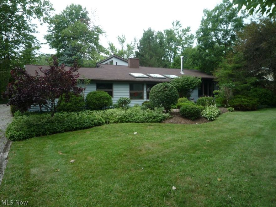 Spacious Ranch, w/three bdrms and two baths. Large living room boasts, natural woodwork, brick and wood burning stove. Kitchen/dining area features ceramic floors, breakfast bar, and a beautiful sitting area w/plenty of natural light. Master bdrm w/exposed beams and full bath.  Bonus room w/office area.  The secluded deck/patio area is perfect for entertaining and opens up to a large backyard. The garages are a car enthusiasts dream. Two/two car garages, one w/work area, heating and storage. Must see to appreciate!