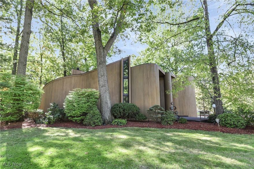 Prepare to be Moved! Welcome to 31105 Roxbury Park Drive, an exceptional residence nestled in the highly coveted Bay Village neighborhood. Designed by Bob Corna and built in 1976 by De Benedetto, this meticulously maintained home offers a unique blend of timeless architecture and sophistication. Enter through the foyer into a grand living room, where soaring ceilings with rich wood detailing, expansive glass doors, and a striking Florida Keys' coral fireplace create an inviting yet elevated ambiance. The seamless flow continues into a formal dining room, perfect for hosting. Into the kitchen featuring granite countertops, an electric cooktop, wall oven, and a Sub-Zero refrigerator.  Just beyond, a charming nook provides the perfect space for casual dining or morning coffee. Down the main hall, you'll find a full bathroom with a newly tiled shower, as well as a versatile office that can easily be converted into a first-floor guest suite. Upstairs, the expansive primary suite is a true retreat, featuring its own private balcony, a custom walk-in closet, and a spa-like ensuite bath with dual vanities, a soaking tub beneath skylights, a separate glass-enclosed shower, and a private water closet.  Two more generously sized bedrooms provide comfort and character—one boasting a private balcony and a unique loft area. A well-appointed full bathroom and a second-floor laundry room enhance everyday convenience. The finished lower level is designed for entertainment and relaxation, offering ample living space, a half bath, a sauna with its own shower, and room for gatherings large or small. Set on a large, wooded lot, the exterior is equally impressive with recently stained siding (2023), updated windows throughout, a stamped concrete patio, and a picturesque gazebo—ideal for outdoor entertaining or quiet reflection.
A rare opportunity to own a home of this caliber in one of Bay Village’s most desirable enclaves—experience elevated living at 31105 Roxbury Park Drive.