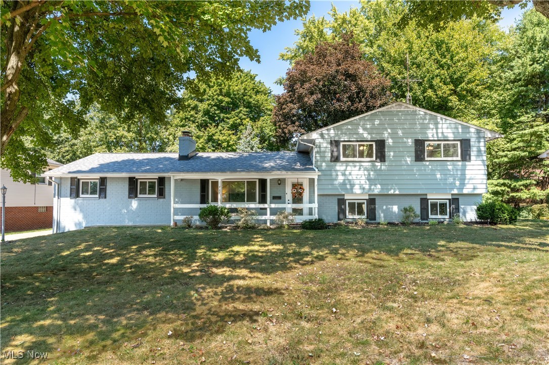 Welcome to this well-maintained split-level in North Canton, featuring three bedrooms, two full bathrooms, and multiple living spaces. The main level includes a spacious living room with a brick wood-burning fireplace and picture window, as well as an updated kitchen with espresso cabinetry, stainless steel appliances, and ceramic tile flooring. From the kitchen, sliding doors open to a bright sunroom surrounded by windows with views of the fenced backyard, adding an additional 216 sq. ft. of living space. Upstairs, you’ll find three bedrooms with hardwood flooring and generous closet space. A full bathroom has been renovated with double sinks, new cabinetry, and a tiled tub surround. The lower level offers a large family room with built-in shelving, plus a second updated full bathroom. The basement provides additional storage and direct access to the backyard and patio area. Conveniently located within walking distance to parks and schools.