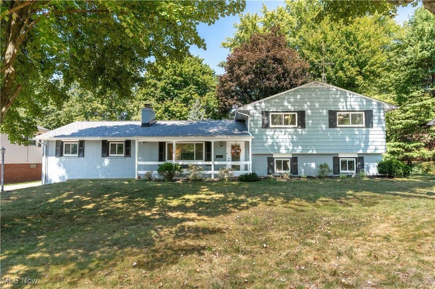 Welcome to this well-maintained split-level in North Canton, featuring three bedrooms, two full bathrooms, and multiple living spaces. The main level includes a spacious living room with a brick wood-burning fireplace and picture window, as well as an updated kitchen with espresso cabinetry, stainless steel appliances, and ceramic tile flooring. From the kitchen, sliding doors open to a bright sunroom surrounded by windows with views of the fenced backyard, adding an additional 216 sq. ft. of living space. Upstairs, you’ll find three bedrooms with hardwood flooring and generous closet space. A full bathroom has been renovated with double sinks, new cabinetry, and a tiled tub surround. The lower level offers a large family room with built-in shelving, plus a second updated full bathroom. The basement provides additional storage and direct access to the backyard and patio area. Conveniently located within walking distance to parks and schools.