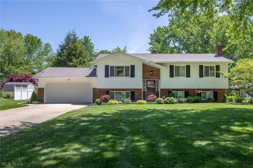 Move right into this beautifully renovated turn-key home and just relax. Nothing to do here! This home features 3 spacious bedrooms on the main floor and a recently updated bathroom. The main floor open layout offers much room for entertaining as well as dining options. The newly re-constructed deck has sliders from both the master and the dining area so that you may enjoy your morning coffee overlooking the private, well-cared for yard with concrete patio. In the lower level, the large 21' x 23' family room has a wood burner that makes for cozy evenings. There is also an additional full bathroom with walk-in shower and bedroom giving options for an in-law suite if needed. The laundry room offers ample storage and access to the attached 2 car heated garage. There is an attractive outbuilding with a metal roof for keeping your yard supplies in.