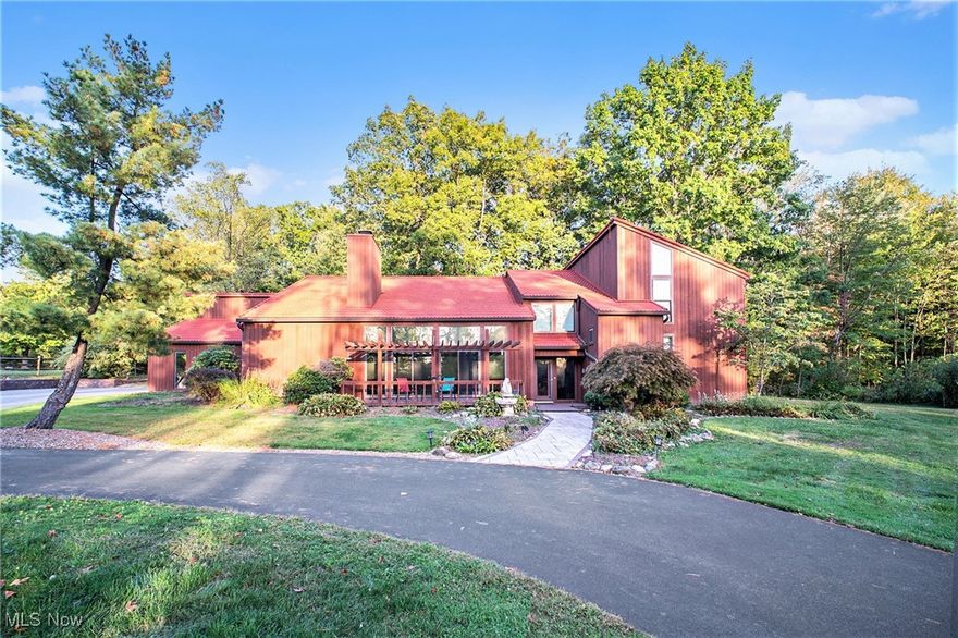 As you pull into the circular driveway, marvel at the beautiful view of the rolling golf course. Continuing on you see the pond and home-notice the metal roof & pergola covered deck. As you open enter, you are welcomed into the 2-story foyer featuring a distinctive chandelier, affectionately known as "Galactica".  To your right is the vaulted living room with engineered hardwood carried through to the dining room. The front wall of newer doors/windows allows the light to pour in. Floor to ceiling remote blinds protects from too much sun. Floor to ceiling stone woodburning fireplace is cozy in the winter. In the dining room, the fireplace is also accessible. Oh, the kitchen! First, it's huge-Featured is the butcher block table, Stainless built-in oven, microwave, dishwasher & newer French door fridge, WINE COOLER & plenty of counterspace. Wet bar open to the Living area, desk, two wall pantries plus a walk-in pantry. The kitchen has access to the family room leading to the multi-tiered deck.  A lovely 4-season room w/a split unit for a/c & heat. There are 2 offices one w/volume ceiling & the other w/garden window. At the other side of the house, there is a fun spiral staircase, walk-in pantry, mud room & half bath. On the second floor, there is a half bath on the landing. The Master is entered through double doors and has a vaulted ceiling. The Master bath has a vanity sink & entrance to the walk-in closet. The bathroom has a freestanding tub w/waterfall faucet, walk-in shower w/Rainforest showerhead. The remaining three bedrooms have a hallway balconied over the Living Room. Two of the bedrooms have built-in bookcases, bench, desk & walk-in closet. The Utility Room is on the 2nd floor where the spiral stair ends. There is an entry for the walk-in attic. The wooded backyard has a multi-tiered deck,  2 story barn w/garage door/opener & electric available! Many upgrades! Easy access Hwys/Turnpike-Minutes to the airport-Close to shopping/Rec Ctr. This home is IT!
