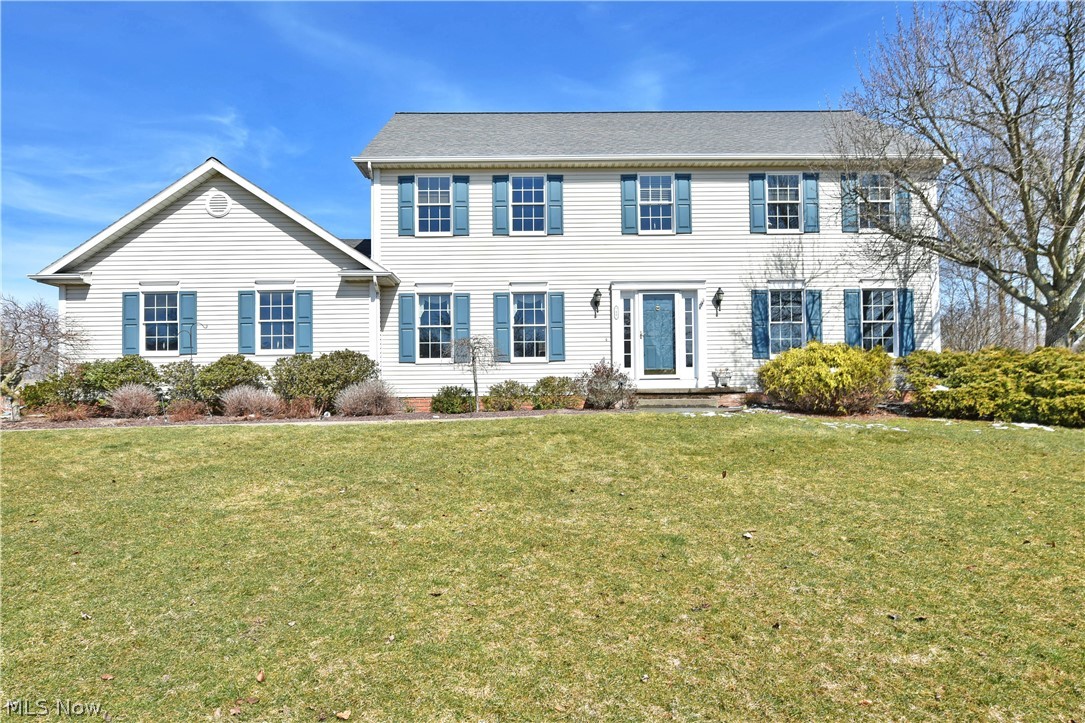 Perched high on the hill of its prominent Canfield lot, this substantial four-bedroom home commands a presence with its spacious, two-story layout! A concrete drive leads up past well-manicured landscaping to find a lush backyard with a relaxing rear patio. A winding sidewalk leads up to the illustrious foyer where sunshine beats down onto the hardwood style flooring below. A posh family room branches away from the carpeted staircase while opposite, the elegant dining room showcases a sculpted, stepped ceiling with wrapping chair rail. An open central layout gives way to the masterful kitchen where polished stone countertops glisten below the recessed lighting. Wood casework accents stainless appliances while casual dining enjoys stunning backyard views from the window lined rear wall. A fireplace filled living room is graced with an elegant bay window for after dinner lounging. A half bath and laundry complete the first floor. Upstairs, the master bedroom suite steals the show with it