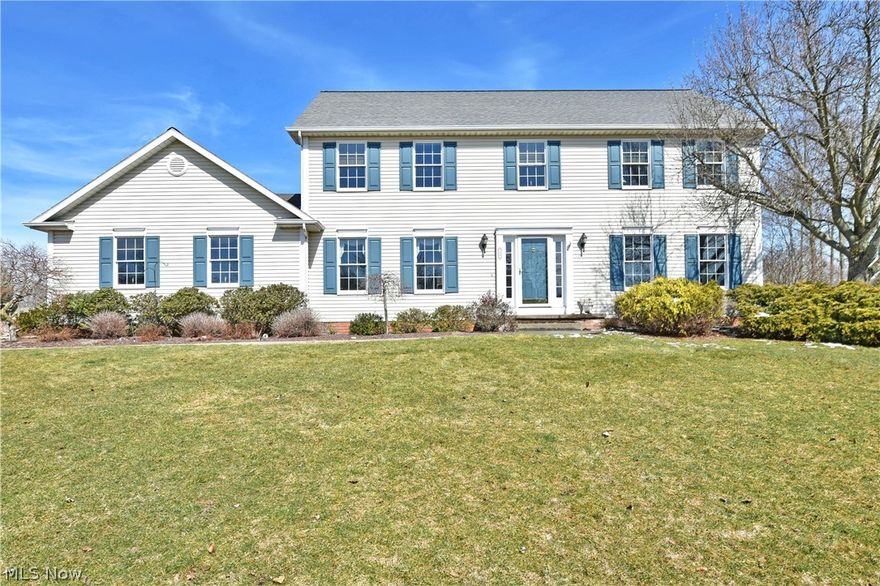 Perched high on the hill of its prominent Canfield lot, this substantial four-bedroom home commands a presence with its spacious, two-story layout! A concrete drive leads up past well-manicured landscaping to find a lush backyard with a relaxing rear patio. A winding sidewalk leads up to the illustrious foyer where sunshine beats down onto the hardwood style flooring below. A posh family room branches away from the carpeted staircase while opposite, the elegant dining room showcases a sculpted, stepped ceiling with wrapping chair rail. An open central layout gives way to the masterful kitchen where polished stone countertops glisten below the recessed lighting. Wood casework accents stainless appliances while casual dining enjoys stunning backyard views from the window lined rear wall. A fireplace filled living room is graced with an elegant bay window for after dinner lounging. A half bath and laundry complete the first floor. Upstairs, the master bedroom suite steals the show with it