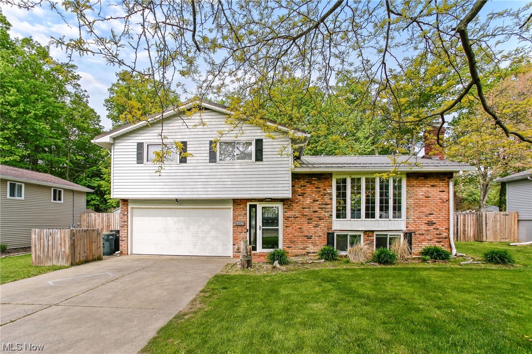 Welcome to this spacious and updated Split Level home located on over .36 of an acre property in Mentor, with a deck and pergola, patio, in-ground pool, and fenced-in backyard with wooded views. This home features 4 bedrooms, 2 full baths, and over 1,682 living sq ft including a lower-level primary bedroom with built-in electric fireplace, which could also be used as a family room, plus a bonus room that could be used as an office or a walk-in closet. An updated eat-in kitchen with lots of cabinet space, double oven range, and a breakfast bar, living room with large bay window, dining room with access to the deck, and 2-car attached garage round out the tour. The home features a metal roof and there is an outdoor shower by the pool. Recently completed improvements include: replaced hot water tank, sump pump, refrigerator, washer/dryer, and pool pump (all 2022), installed carpet in living room, upstairs hall, and on stairs (2022), accent wallpaper in living room/kitchen, front window blackout blinds (2022), painted front door exterior and painted throughout (2022). INCLUDED are ALL kitchen appliances, washer/dryer, doorbell camera, all wall-mounted TVs and mounts, bunk bed, all window treatments, both sheds, pool accessories, playset, picnic table, tree swing, and pergola lights. Conveniently located just minutes from Lake Erie and near OH-2, OH-306, I-90, Great Lakes Mall, plenty of other shopping, restaurants, and local attractions.