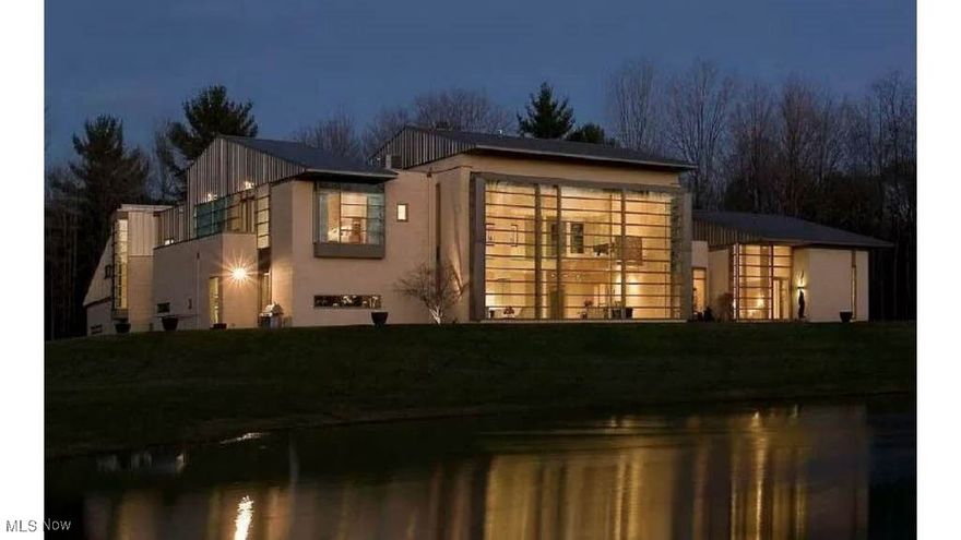 Contemporary architectural masterpiece! Breathtaking 40' x 20' high glass wall allows you to enjoy the beautiful natural setting as the seasons change. Incredible build quality!  The house is in "move-in" condition. Just bring your toothbrush! Master bedroom has "his" and "hers" bathrooms which are separated by a large walk-in closet with custom built-ins. "Hers" bathroom has a large jetted tub and a glass shower. "His" bathroom has a large shower with a glass wall and steam unit. Master bedroom has a fireplace, French doors to the outside patio, and circular stairway to the exercise room and second floor.  Guest suite/second master on the second floor with vaulted ceiling and glamor bathroom.  3 additional bedrooms on the second floor with private bathrooms including a custom glass elliptical shower and a private 2nd floor patio. Comfortable and large family room with a unique entertainment center. A genuine "Chef's kitchen" with custom island, walk-in pantry, and eat-in kitchen area. Large wine room with its own cooling unit in the basement.  10' high ceilings on the first floor, 25' high ceiling in the living room/dining room, and 20' high ceiling in the master bedroom.  9' high ceilings on the second floor with a vaulted ceiling in the second floor mater/guest suite. 5 separate HVAC units plus hot water heated garage floor.  Bedrooms have individual zone controls.  Fresh air units assure tempered, fresh air is circulated constantly. 4.5 car garage with ceramic tile floor and epoxy coated painted and ceiling and EV charger. Whole house standby generator (natural gas).  Fenced in dog run. 6.5 acre wooded lot including 1 acre lake provides the backdrop for this truly one of a kind contemporary home.  This architectural masterpiece is a truly spectacular home and a must-see.