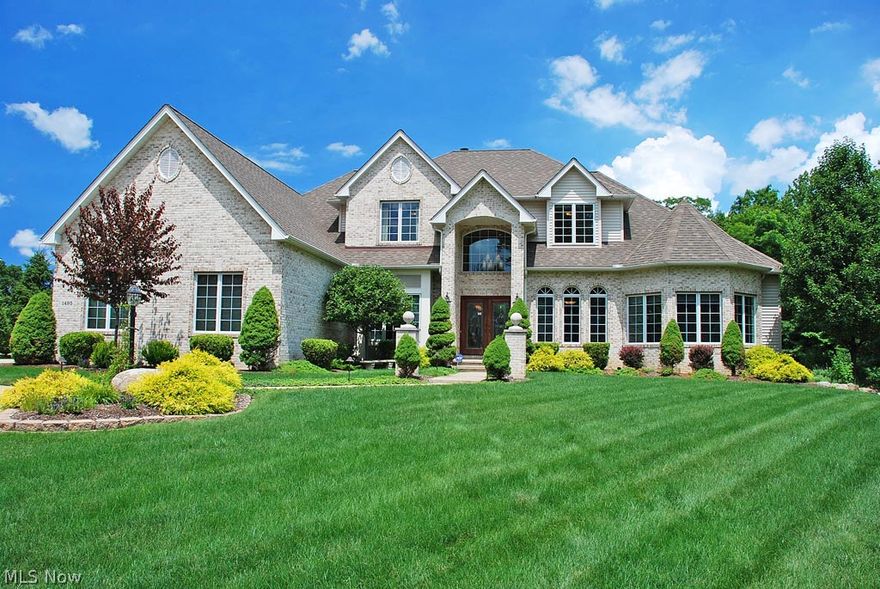 Surround yourself in sophisticated luxury--this elegantly-appointed, custom-built home won the 2003 Cleveland Choice Award for Best Design and has received 110K+ in updates since 2010. The lavish interior is filled with extensive millwork, unique niches, opulent lighting, rich wood flooring, & solid wood 8’ doors. The kitchen beckons you to sit by the fire in the hearth room or to try a new recipe in gourmet-style…warm, cherry cabinets, 2 SubZero freezer drawers, a 36” SubZero refrigerator, 2 Jenn-Air wall ovens, a Fisher-Paykal 5-burner gas cooktop, & a butler’s pantry. Relax in the sunken, light-filled 2-story great room with a beautiful fireplace or retire to the elegantly-appointed library w/box beam ceiling and custom built-ins. The first floor master is a dream come true & the sumptuous, tastefully-appointed master bath makes for a perfect ending to the day. There are three bedrooms upstairs, two with a jack-n-jill & one with private bath. Entertaining options await you and your