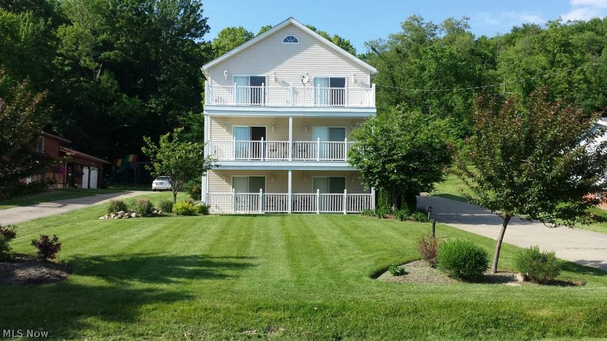 2 full kitchens, 3 living rooms, 4 bedrooms, 5 baths, 2 balconies, 4 car garage on level / flat property near the beach--and more!