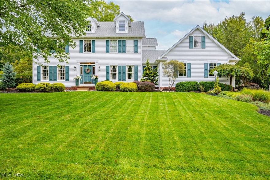 Back on the market! Priced to sell with a refreshed main bedroom and bathroom. There are still some gorgeous autumn days left to enjoy the hardscaped backyard and gas fire pit. Roof, siding, downspouts/gutters - all replaced in 2020.

This 4 bedroom, 2.5 bath custom colonial home was one of the first built in the Mayfair Lakes development, filled to the brim with quality finishes, and lovingly cared-for by one owner. The interior design gives a classic, coastal-cool feeling that invites you from the main entry and sitting room, through the glass French doors, and into the spacious living room to take a seat by the fireplace.

White-washed oak cabinets and cream tile floors continue the airy flow into the kitchen, complete with eat-in area, kitchen island, and included stainless steel and black appliances. The first floor laundry, quiet den with wood flooring, half bath and 2+ car garage round out the main floor of this spectacular home.

Following the real grass cloth covered walls up the stairs to the second level, you’ll find 4 generously sized bedrooms. The primary bedroom, complete with ensuite bathroom and walk-in closet, draws your eyes up toward the vaulted ceiling. The 3 remaining bedrooms and full bathroom on this level are sure to provide plenty of space and storage areas. The HVAC system includes a high efficiency furnace and AC, installed in 2016.

The final “piece de resistance” is the show-stopping hardscape patio overlooking a fountain and pond. Ninety-three authentic Wooster barn stones make up the 3 tiers of seating areas, gas fire pit, natural waterfall and outdoor kitchen with a sandstone top. A top-of-the-line Coyote grill and side fridge will allow you to spend more time with your guests in the great outdoors.