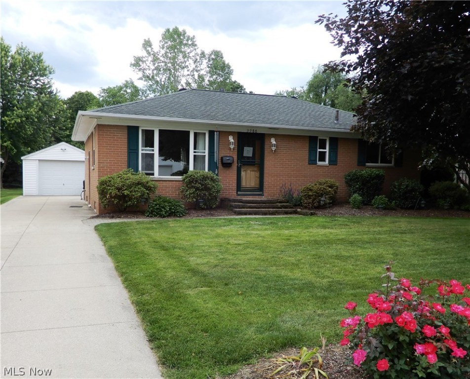 Fall in love with this absolute gem in Mogadore. Nothing to do but move in to this adorable all brick 3 bedroom, 2 full bath ranch, 1 car garage and tons of updates! Great floor plan features an open kitchen (all appliances included!) with dining area, bright living room w/recently refinished hard wood flooring, 3 bedrooms all with hardwood floors, and a modern full bath! Downstairs you will love the huge recreation/media room, huge laundry area (washer/dryer included!), gorgeous FULL bath, and spacious workshop/storage area. Outside you will find beautifully manicured lawn/landscaping, nice flat yard, and a huge brick patio perfect for entertaining! Updates include: roof 2009 (30 year shingles), updated full bath (lower level), kitchen with newer cabinets and ceramic tile flooring, newer windows, new microwave and dishwasher, and neutral decor throughout. Freezer in basement stays. Don't let this one pass you by!