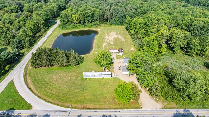 Perfect Building site: 5 Acres with a 1 Acre Pond, Driveway, electric, water well, septic, all in place! There's a 24x24 garage and a nice 30x40 metal frame outbuilding with 2 overhead doors, 10 ft door height. All footing is in place to pour concrete in the outbuilding. The trailers are not included. This is an excellent opportunity to build your dream home with a beautiful water view. The pond is stocked. Could also make a wonderful recreational site. Close access to Pymatuning Lake, the beach and boat launches. Richmond Township has no zoning, so bring your ideas and make them happen!