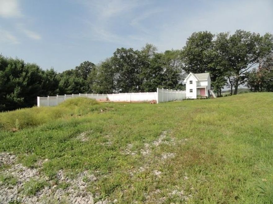 Nice 1 Acre building lot with L shaped in ground pool, white vinyl fencing, hot tub & large play house is ready for your new home.  County water & septic system on property.