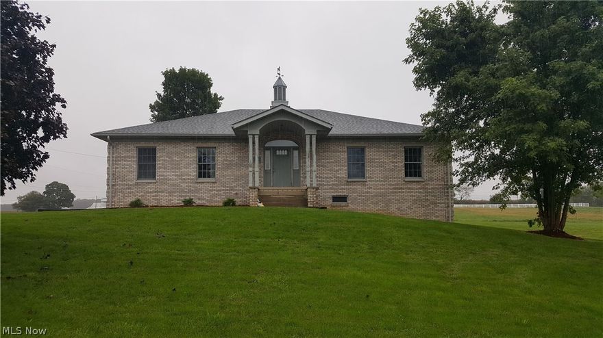 Formerly the headquarters of the Percheron Horse Association of America this a very desirable property in a highly visible location just north of Fredericktown Ohio. Situated on 14.5 acres, which is zoned M-1 (light manufacturing), this offering has frontage on Zolman & Quaker Roads and SR 13. The 40’x55’ all brick office building was built in 1992 and has 2200 square ft. on the main floor which includes a large private office, a boardroom, a spacious office area with several stations, a small waiting room and men’s & ladies’ restrooms. Plenty of built-ins throughout. The full walkout basement has a meeting area with kitchenette, storage/filing area, and a full bath. Electric heat pump forced air heat & central air conditioning. Has private water well and septic system. Other improvements include a 40’x60’ pole-built horse barn (1994) with an 18’x60’ lean-to for storage. Inside the barn there are 6 permanent tie stalls and room for portable box stalls, storage etc. The outside has a la