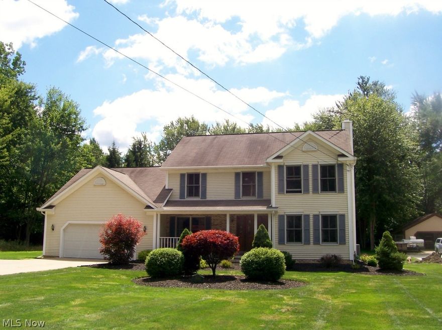 Custom built colonial nestled on 2+ acres on picturesque Reeves Rd. Warm and inviting living room and family room with gas Fire Place. Large dining room leads to gorgeous kitchen all new in 2010 with top of the line appliances.  This lovely home has four bedrooms up and three freshly painted full baths and one half bath all with newer fixtures. A laundry room conveniently located on the first floor.  New furnace in December 2011 with Pure Air Filter System and new Air Conditioner in December of 2011.  New carpet in 2013 in family room and leading up steps to second floor.  The garage has both cold and hot water and is a 2.5 car garage with extra storage space too.  The roof has gutter gloves new in 2011.  Huge shed in the beautiful back yard.  Sit on the cozy front porch or entertain on the stamped concrete patio in back with peaked roof overhead.  Nothing to do but enjoy the view!