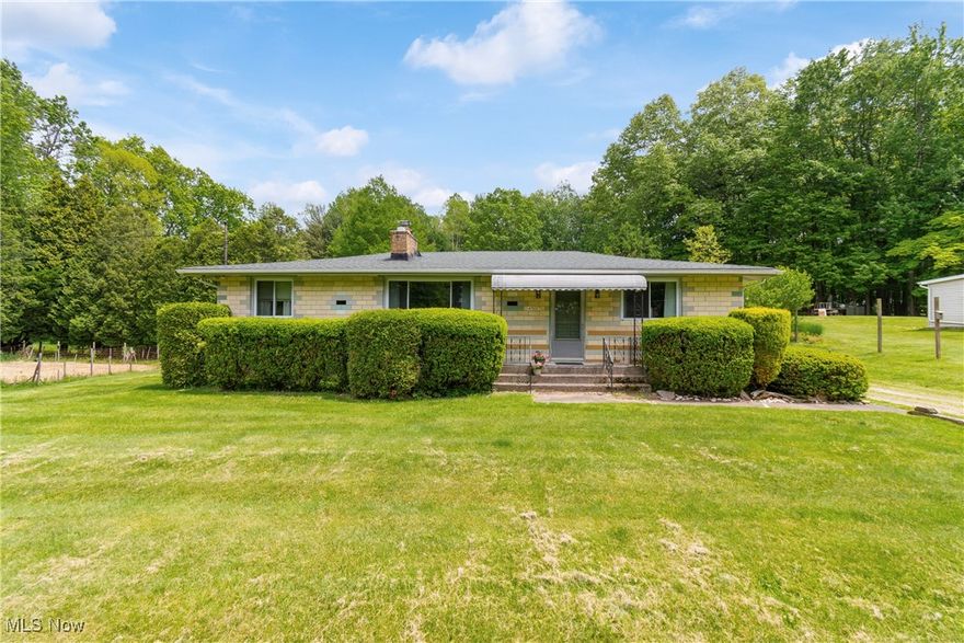 Nestled on a private road in the City of Green, this solid mid-century ranch on a beautiful 1.3 acres is waiting for your finishing touches! Featuring 3 bedrooms, 1.5 baths, and a lower level rec room. Main living area has cozy wood burning fireplace with newer insert. Newer roof, windows, and septic sump pump. Hard wood under carpet in living room, hallway, and bedrooms. Master bedroom features a half bath. Lower level recreation room w/ bar, utility, laundry/workshop, and lots of storage!  Peaceful and quiet area with nature at your doorstep and an amazing yard. The property has covered back porch - a great spot for watching the wildlife while having your morning coffee, a boat garage/shed (could also be used as 1 car), an extra large storage shed, and huge garden. Close to Nimisila Reservoir with walking trails & great fishing. Grab your kayak and your fishing pole and don't miss the opportunity to make this one your own, call today!