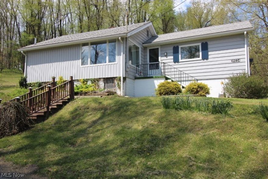 Located on the outskirts of Lisbon on over an acre, this may be the one! Easy access to SR 11. This home features a spacious living room, eat-in updated kitchen with appliances included, 3 bedrooms with wood flooring and full bath. Finished room with fireplace in basement. Enjoy the wonderful yard  from the back deck.  Also has a detached garage and shed. This home has vinyl siding and the 30 yr.dimensional shingle/roof is about 10 yrs old, Kinetico water system and newer windows.