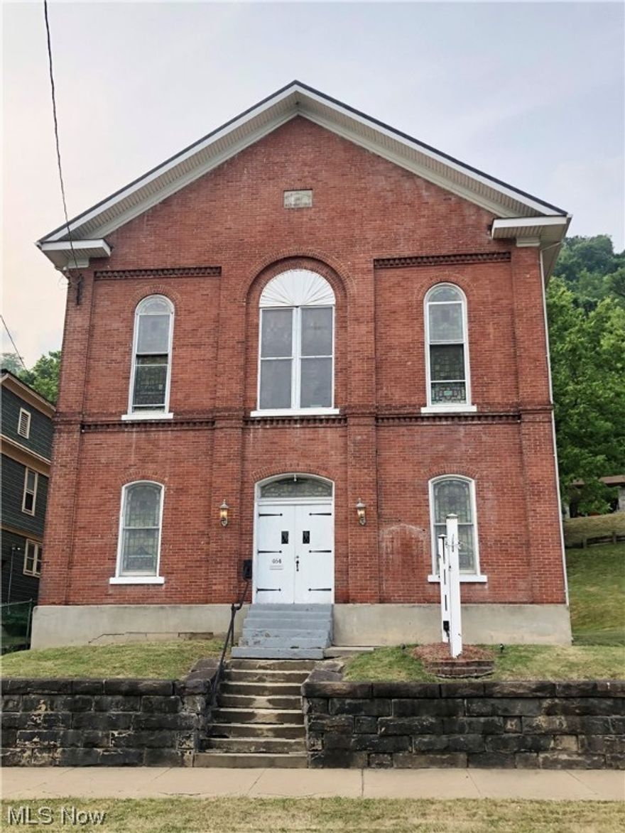 This beautiful brick structure was most recently used as a church. As a new owner, bring your imagination to take advantage of all the square footage this building has to offer. The metal roof was installed on the main part of the building in 2019. The first level of the building was renovated around 2013-2014 and included new painting and carpeting, light fixtures, trim, etc. The first floor features four separate rooms that could work well as bedrooms (closets and windows would need to be added). The gas furnace and air downstairs was installed around 2014. The air conditioning for the second floor was installed in 2020. The two sets of winding staircases lead you up to the second floor where you will find the sanctuary. This level is highlighted by the beautiful stained glass windows. Another set of stairs will lead you to the third floor balcony. There are three total parcels included in this listing (one of which is across the road).