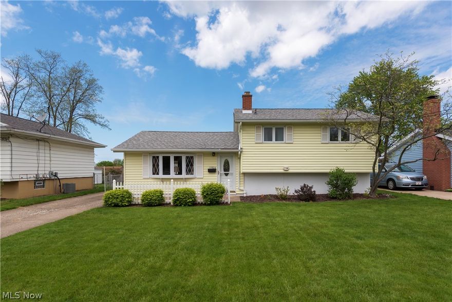 Say hello to this clean Brook Park Split-level on a quiet tree lined street!  The first floor is an open concept including the living room with lovely stained molding, a bay window, wall to wall carpet , newer windows and doors, and a front coat closet. The eat-in-kitchen is spacious enough for entertaining and has a slider leading to the 19x10 covered back patio. The second floor has three bedrooms, all with original hardwood flooring under the carpeting. A double wide closet adds additional storage in the master bedroom. An ample linen closet is just steps away from the 2nd floor bathroom with an original deep tub and mottled glass window. The lower level has a built in bar, carpeting, and access to the back patio and yard. Additionally the lower level laundry room has amazing built in storage, a stall shower, and houses the newer water tank and high efficiency Furnace. You will find a clean, fully floored attic space above the second floor via pull down stairs for your storage needs. The garage has a newer Craftsman opener, a keyed man door, and another overhead storage space. There is a built in work bench, and underground electrical. The fully fenced yard is a stunner with a well kept lawn, and newer landscaping. The front porch is sized for sitting and enjoying the quiet non cut through street. Make an appointment to come see this outstanding Brook Park house before it's gone!