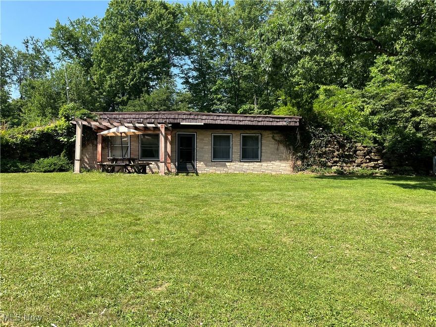 How would you like to wake up to the sound of birds singing and wildlife pacing by your window? Then you will feel right at home at 382 Bluestone Dr.! Step into 1,368 sq ft. of comfortable one-level living featuring a spacious living room, cozy dining nook and galley kitchen with so much counter space! This 2 non-conforming bedrooms, 2 full bath home is built on a crawl space and has a low maintenance rubber roof. There is a huge garage with water hookup perfect for storing your vehicle and Husqvarna riding mower, which transfers with the home. This beautiful 12 acres property comes with ample space for gardening, recreational activities or just room to breathe.The possibilities are endless. This is a diamond in the rough waiting for your imagination. Don't miss this rare opportunity to own this beautiful property and get reconnected with nature. There are pear and apple trees on property as well as chestnuts. Property does not fall within the flood zone.