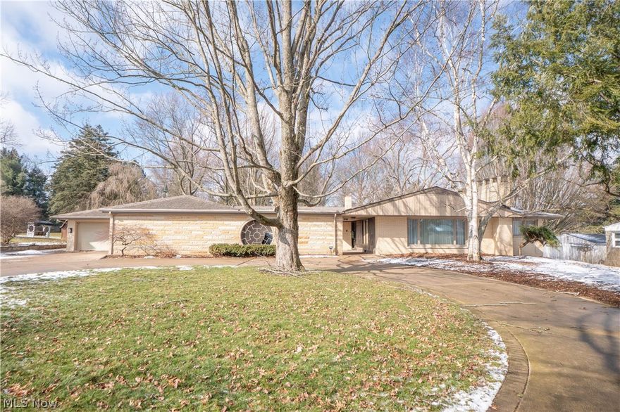 Beautifully updated 3 bedroom, 4 full bath ranch offering over 4,100 sq ft of finished living space! The foyer opens to a bright living room with new carpet and great natural light. The renovated kitchen features LVP flooring, leathered granite counters, a huge island with breakfast bar, soft-close cabinetry, stainless appliances, tile backsplash, and sliding doors to the covered composite deck. Dining room includes LVP flooring and chandelier lighting. Two first floor bedrooms have new carpet and ample closet space, with an updated full bath featuring double sinks and a tub/shower combo. First floor laundry includes utility sink and storage. The spacious primary suite offers new carpet, skylights, electric fireplace, sitting area, two walk-in closets, and sliding doors to a heated brick patio. The suite includes two full baths one with a walk in shower and one with a soaking/jetted tub and double sinks. The remodeled basement adds a large rec room with new flooring, gym room, multiple storage areas, egress windows, walkout to a covered patio, and a full bath. Backup generator included. Exterior highlights over an acre of yard, multi-level composite deck with built in seating, heated brick patio, front brick courtyard, wrap around paved brick driveway with heated sections, and a 5-stall heated garage with built ins, workbench, floor drain, and water access. Immediate occupancy available!