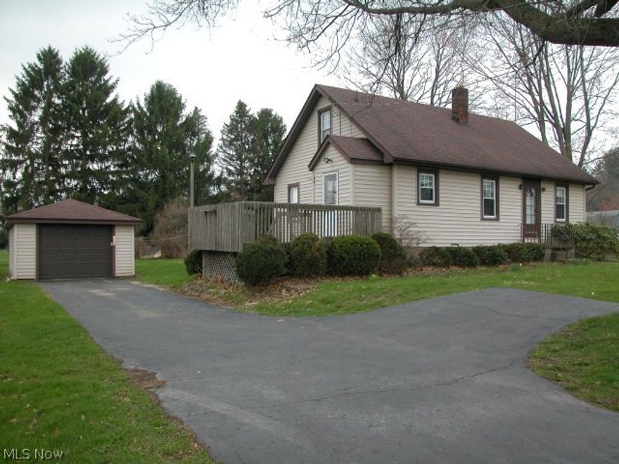 Priced to sell this cape cod home sites on 3.04 acres close to OARDC. 3BR, 1BA, walkout basement, newer tilt in windows, water heater, roof shingles, furnace & AC, vinyl siding. An oversized 1 car garage plus a 28x20 barn great for those 4H projects or convert to wonderful workshop.  Orchard to the back of the property. Hardwood floors under carpet.  Just add your decorating touches & details and this is a real find.  Home is being sold "as is".  Plan on doing the "small stuff" because all the big ticket items are done!