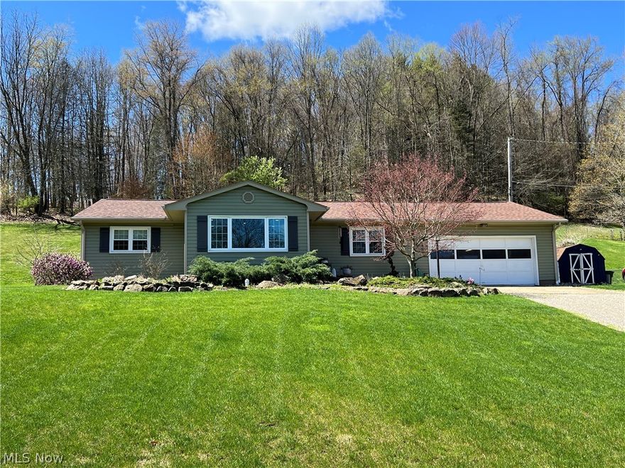 Well maintained 3 bedroom, 2 bath vinyl sided ranch home.  Charming paver entryway.  Updated, neutral decor with new lighting fixtures throughout.  New vinyl laminate flooring in the living and dining rooms with new white trim.  Freshly painted white kitchen featuring subway tile backsplash, granite counters and new shiplap accent wall.  Solid surface vanity in the main floor bath with double sinks.  Rec room in the lower level with freshly painted full bath.  200 amp electric.  Vinyl replacement windows throughout.  Large rear paver patio boasts built in firepit, overhead lighting and private back yard make this a fantastic place to entertain!  Additional updates including new septic in 2022, new gas furnace in 2022.  Half acre, peaceful country setting, just outside of town.  A must see home, don't miss this.