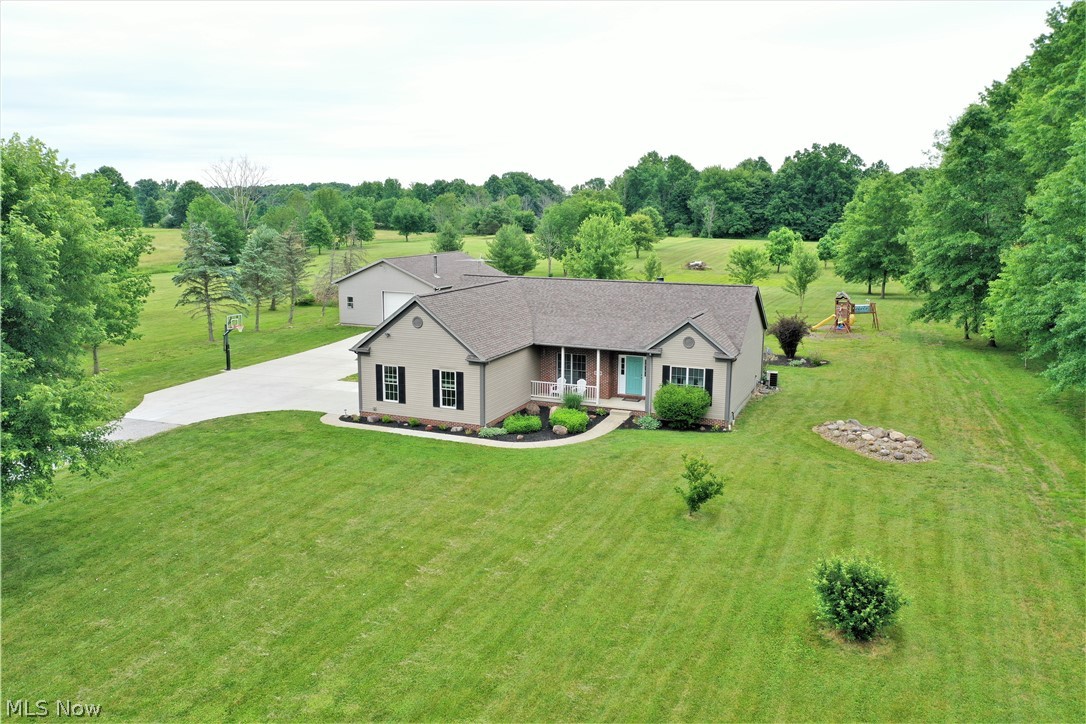 Postcard setting! Wow! Welcome to these 7 acres of tranquil setting, three-bedroom, two full bath ranch home. Come on in from the front porch to the inviting foyer which is open to the large living room offering a brick fireplace with mantle and the bright kitchen. Freshly painted and new modern lighting, new vinyl plank throughout. The luxury chef's kitchen offers Quartz counters, soft close cabinets, high-end stainless-steel appliances, bar counter, and is open to the dining area with plenty of windows to let the natural light to shine through and has a slider door to the large backyard deck where you can sit out and enjoy the gorgeous views. There is another room off of the kitchen currently used as a play area but could be an office etc. Still on the first level there are three bedrooms with new carpet, remodeled guest bathroom and the master suite has a full bathroom with his and her sinks. Mudroom, laundry room. The large lower level is unfinished offering more room for storage.