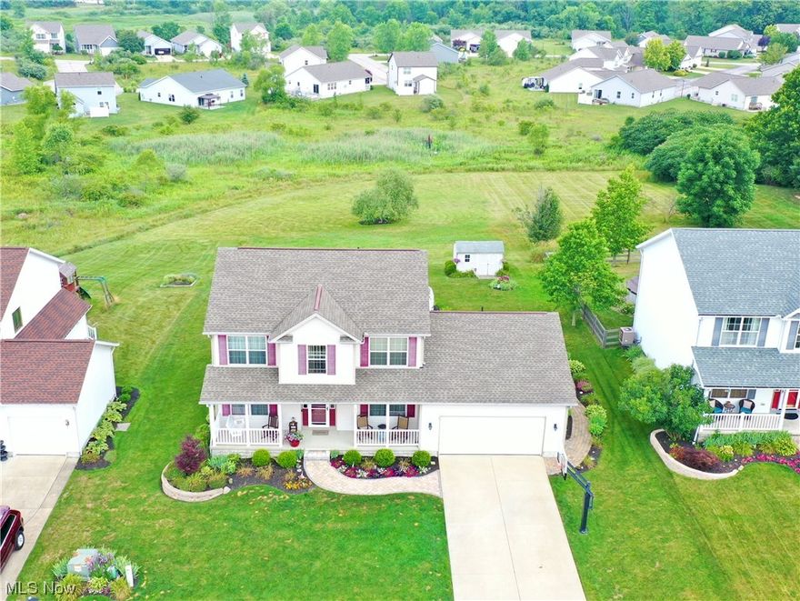The PERFECT place to call home sweet home, welcome to 5300 Meadow Park Drive in Brimfield's Marsh Landing development! As you approach this lovely home, you'll be welcomed with a winding, paver-lined sidewalk leading past lush and immaculately maintained flowerbeds to the charming front porch. The exterior of this home has been lovingly cared for with beautiful landscaping and comfortable and relaxing areas to enjoy. With a composite deck, aboveground pool, patio, and shed, this home offers a private back yard surrounded by neighborhood green space which will ensure you that you will never have any new neighbors behind the back yard! Stepping inside, you will immediately notice how clean and well-kept it truly is. Throughout the first floor, there is gorgeous LVT flooring which was installed less than two years ago. A gas fireplace can be found in the living room making it a cozy place to relax. The eat-in kitchen offers plenty of counter and cupboard space with newer stainless appliances and an awesome view out the sliding glass door. A first floor laundry and half bath right inside the garage door are a wonderful convenience. Heading upstairs, you will find 3 nicely sized bedrooms and full bath plus a large master suite with vaulted ceiling, walk-in closet, garden tub, and dual sinks. The basement has been fully finished to offer plenty of living, rec, and storage space. Overall, this one-owner home is a winner! Ready to move in and be loved, schedule your showing today!