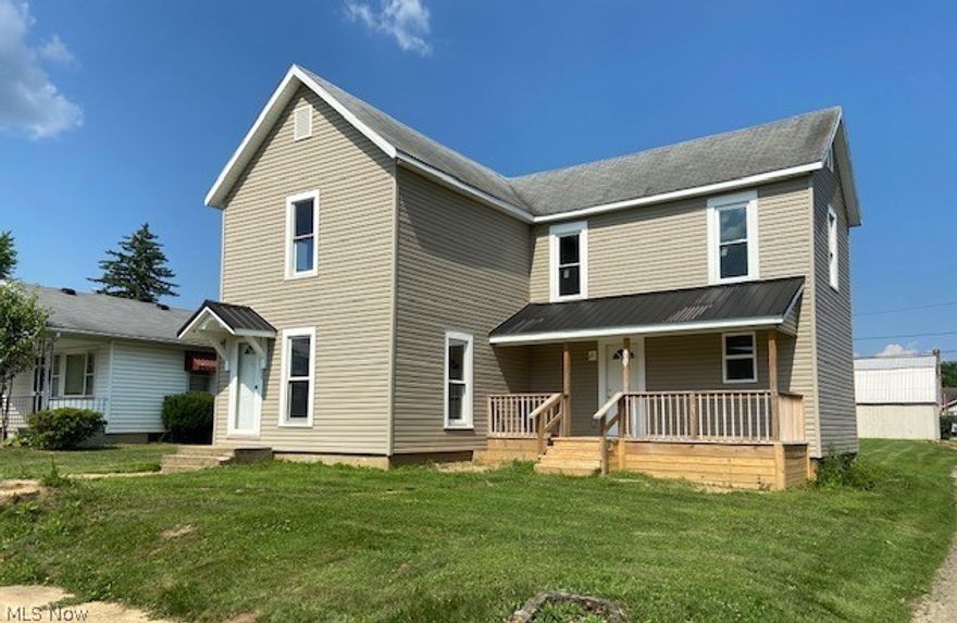 Totally renovated in tasteful decor. New white kitchen, laminate flooring. Full bathroom on first floor. Dining room and large living room has open staircase with contemporary flare. There is a spacious walk-in closet in the dining area. New windows, carpet, walls, light fixtures. Steel entrance doors. Two great covered porches. One is an exceptionally large and deep covered porch on the back of the house. Front porch leads to the kitchen area. There is also a front door entrance to the living room. 3 large bedrooms, full bath and BONUS!- large, convenient 2nd floor laundry. New wiring, plumbing, furnace, air, metal roof on first floor. The white trim and color scheme is a fresh look throughout. Many windows. Bright and cheery. Large, level corner lot has plenty of room for off-street parking or a garage. Must see!