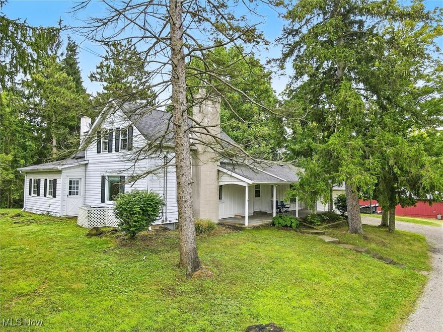 Welcome to this 1,500 sq. ft. charming century home, filled with character and potential, nestled on nearly 3 picturesque acres in the desirable Chardon School District.  This farmhouse style home was updated in the 1970s and offers a warm, inviting layout. The kitchen features solid hardwood cabinets, while the dining room sits conveniently off the side covered porch. The living room boasts hardwood flooring, a wood-burning stove, and classic wood paneling. A converted front porch now serves as a cozy four-season room with electric baseboard heat, perfect for year-round enjoyment. The first floor also includes a bedroom with hardwood flooring, a den, laundry room, full bath, and an oversized pantry. Upstairs you’ll find an additional bedroom, another full bathroom, and a spacious bonus room with a closet—ideal as a primary bedroom retreat. A two-car attached garage provides everyday convenience, while the massive multi-section outbuilding is a true highlight. The main section includes a coal burner, storage racks, an overhead door, and barn-style swing doors. Three additional sections each feature their own garage and man doors—perfect for storing RVs, boats, cars, or creating multiple workshops. This property blends charm, functionality, and endless opportunities in a peaceful country setting. A 1-year Home Warranty is included.