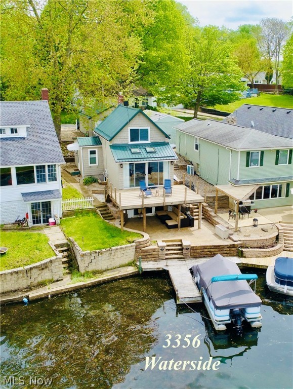 Move in condition! Lowest price main chain of Portage Lakes! Adorable Cape with finished walk-out lower level. 2013 metal roof with 40 year transferable warranty. 2014 all windows and slider with life-time transferable warranty. Large deck 2018 with beautiful sunset views. Deck also has metal roofing and gutters under to enjoy professionally landscaped stamped concrete patio with walk around pavers for rainy day sunset views. Maintenance free Versa-lok walls. Two car garage with parking for 4 more cars. 2020 hot water tank. 2017 well pump. 100 amp electrical service. Second floor bedroom has room to add full bath. Private tranquil bay just minutes from Turkeyfoot Lake speed zone.+Square footage above includes Finished walk out lower Level! Irregular lot 43ft on road 27 ft frontage on Lake. Great summer cottage or year round lakefront lifestyle!