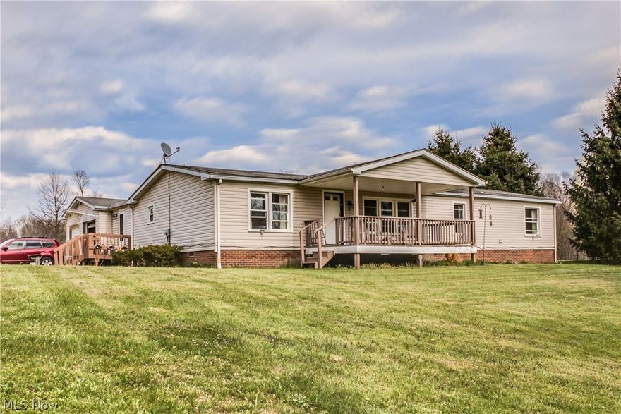Don't miss this amazing opportunity! Manufactured Ranch home on 7.06 acre lot. Attached 2 car garage. Enjoy spectacular sunsets from the comfort of your front porch. Bask in the serene privacy of the back deck. Spacious open floor plan. Upgraded windows are vinyl, double hung, with double pane glass. Septic system was inspected in 2015. New water heater & pressure tank in 2016. Interior freshly painted! 280 sq. ft. built addition. Driveway Access Is Easement On Adjoining Parcel.