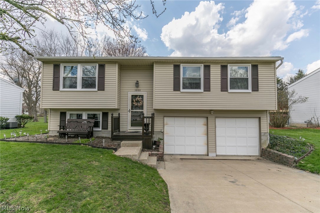 JUST MOVE RIGHT IN ! Three Beds with TWO FULL baths in this vinyl-clad, newly-windowed Bi-level Beauty, boasting wood plank flooring with 2011 roof, water heater and AC. Beautiful Granite Kitchen with newer disposal; added dishwasher & microwave, 2013. Gorgeous wood flooring throughout except carpeted living/family rooms & tiled laundry. Second FULL bath Professionally Designed & constructed in lower level, 2013. Replacement windows, gutters, 2016. LOCATION, LOCATION, LOCATION: When you aren't enjoying your yard, house and deck, your travel will be very light to schools, shopping, parks, trails, restaurants and highways!!! Three minute drive to downtown Kent & 5 minutes to Kent State U! Both garage doors w/ new openers, 2017; new front screen door & rear screen door to deck. Beautiful brick fireplace in lower level family room= new gas logs, 2013. Fully fenced (chain link) back yard with two gates, 2015. Newly-stained two-tier deck with swing, summer 2017. SO MANY UPDATES the list may