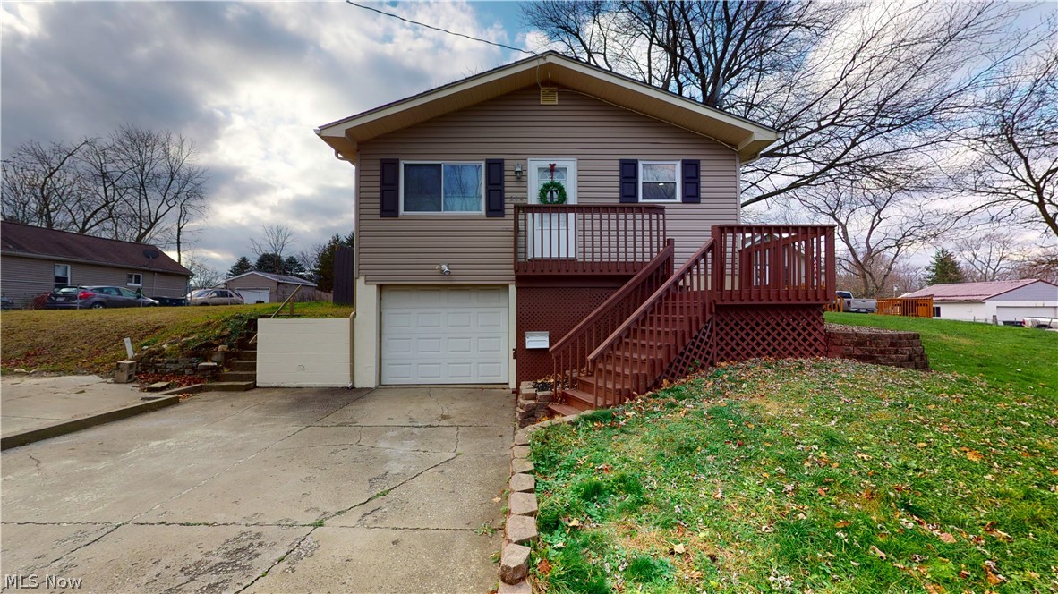 Wonderful Raised Ranch with spacious living room with hardwood floors, open to eating area/dining room with built-in buffet area and updated, fully applianced kitchen. Also on first floor is 3 bedrooms and updated full bathroom with granite vanity and ceramic floor and shower. Largest bedroom has sliders to deck, overlooking fully fenced-in backyard. Lower level has possible in-law suite with family room with wet bar/sink, large bedroom, and full bathroom with step-in shower. There is separate entrance from garage or side door. Large laundry/utility room downstairs also, along with 1-car attached garage with opener, water and drain. Updates include siding 2019, central air 2013, 2009 = newer roof, vinyl windows, gutter, rear deck. Also, newer front door, canned lighting, ceiling fans. Washer, Dryer and Home Warranty included! Make your appointment now to see your NEW HOME! (Portable fireplace in lower level does not stay). (There is a vacant lot next door for sale with diffe