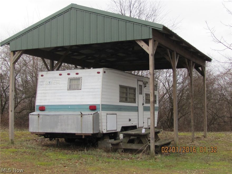 Nice wooded acreage with view of Wills Creek, rock formations and stream totaling 13.976 acres in two parcels 0210000014910 and 0210000014909. The property adjoins Muskingum Watershed Conservancy district. There is an old camper and newer shelter. Electric is on the property and metered. Shared drive. No mineral rights- Seller does not own them.