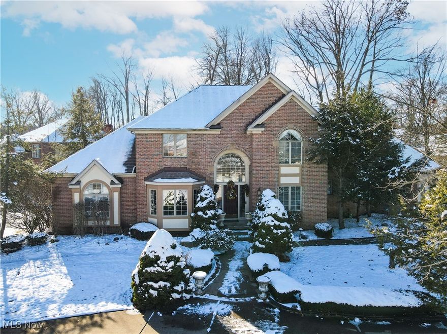 Beautifully updated, move-in ready, 4 bed 5 bath colonial in Rosemont Ridge, located in Fairlawn. Situated on a corner lot, this 4900+ sqft brick home features a first floor master suite with bay window. Welcoming two-story foyer opens to a spacious, light-filled layout with a formal dining room with tray ceiling, office with wood paneling, built in bookshelf, and bay window, large great room with wall of windows, and a sunken family room with custom built-ins, including great fireplace. Perfect for entertaining, this spacious kitchen features large center island, built in microwave with wall oven, granite counters, ss appliances, vaulted ceilings, and plenty of storage and counter space. Eating area walks out to private deck. Spacious first floor master suite with 9ft tray ceiling, two walk-in closets, bathroom highlighted by jacuzzi tub, dual vanities, and large shower. First floor laundry room with built-in dog wash adds extra convenience and storage space. Upstairs includes three generously sized bedrooms: an en-suite bedroom and two connected by a Jack-and-Jill bath. The finished lower level features a wet bar, gas fireplace, entertainment area, fitness room (equipment stays), theater room, half bath, and storage. Circular drive welcomes guests & is separate from drive way to 3 car garage. A walkway connects the two drives to the front door.  Recent updates include: hot water tank (2018), furnace and two A/C (2022 & 2025). Convenient location minutes from Montrose shopping, restaurants, parks, and highway access.