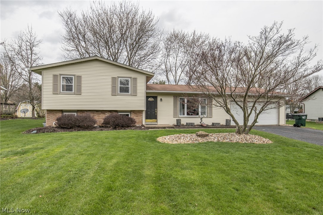 Beautifully updated split level home on a large lot in Diamond Estates. Offering 1573 sq ft, newer laminate flooring, carpet and paint throughout. The living room has beautiful large windows, filling the room with natural light, and is open to the dining room and kitchen. Down one level, you'll find a spacious family room with brand new carpet and paint, and utility/laundry room. Upstairs, you will find 3 spacious bedrooms, and a modernly updated bathroom complete with subway tile surround, and granite vanity. Enjoy spending time on your deck over looking your nice sized back yard. There is plenty of vehicle and extra storage in the two-car attached garage. Call for your private showing today!