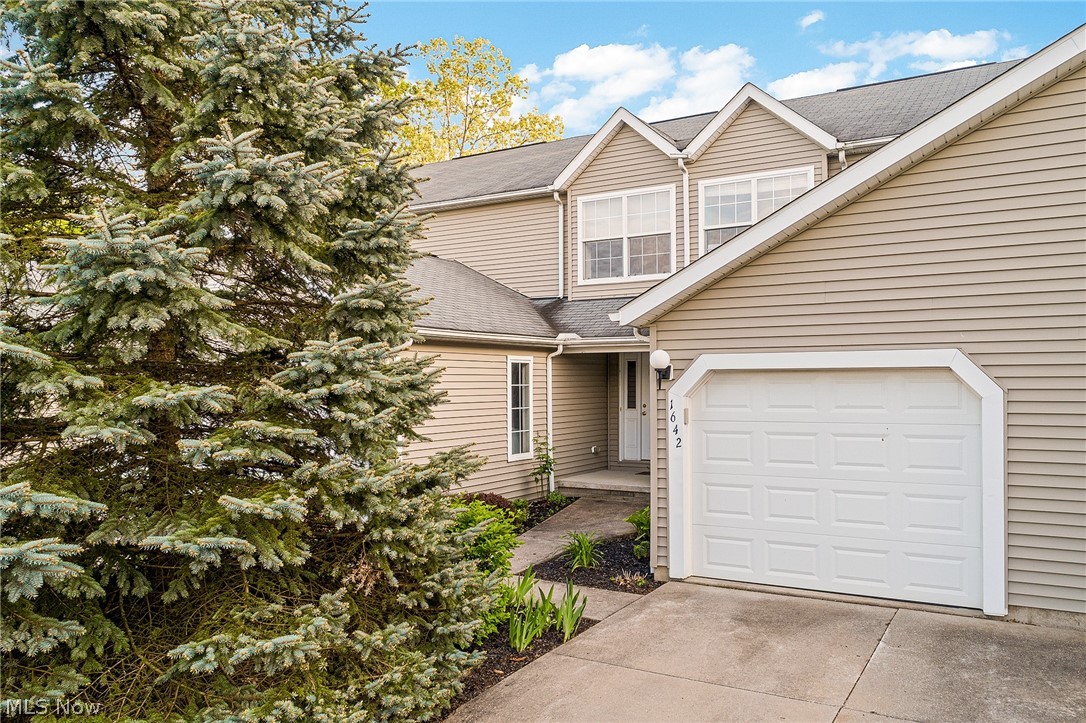 Welcome to 1642 Maple View Ct, located in the lovely Maplewood development. This 2 bed, 2.5 bath condo features an open floor plan on the main level and vaulted ceilings on the second floor, giving this home a bright and open feel. The kitchen looks out into the living room and has a newer stove and refrigerator (2013). Enjoy your private patio space, accessed through the sliding glass door off the living room. A half-bath and garage access complete the main level. Both bedrooms, on the 2nd floor, are generously sized and offer double closets. The full bath is accessible from the master bedroom and also from the hallway. For additional living space, you'll appreciate the finished lower level that includes another full bathroom and plenty of storage. You'll also find a separate laundry room here that features a convenient utility sink with washer/dryer included. Other perks to this home include a water softener (2013), newer hot water tank (2017), and a new AC replaced just last summer.
