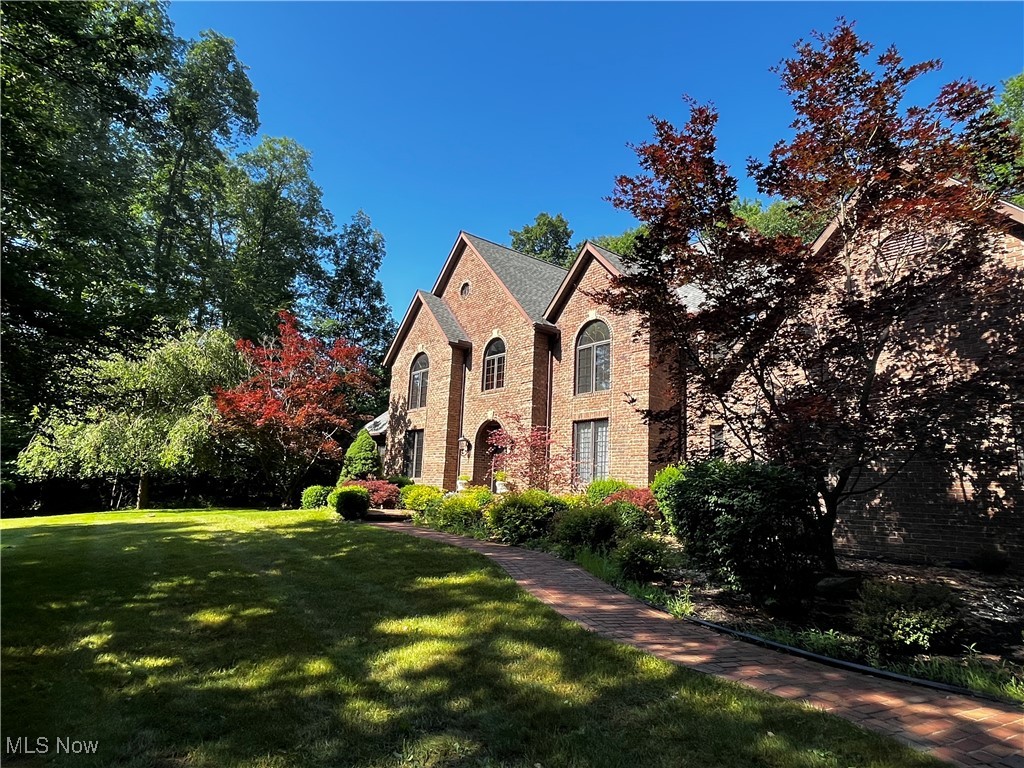 Custom built brick Colonial on a 3.5 acre lot (Richfield Township ) including private enclosed pasture and 2,400 Sq. Ft. Horse Barn. This lot has been tastefully developed for privacy. Bring your own horses or lease the barn for this popular recreation in the heart of Richfield. This property also included an active natural gas well serving the home. Walking up and into this traditionally built custom home, you can appreciate and respect the elegant two story foyer with open natural wood stairway and natural light and marble flooring. The foyer opens into the stunning two story great room with hardwood floors, marble hearth fireplace, a view of the private yard, and a second open natural wood stairway. The great room is accented with rich natural wood paneling, traditional natural wood trim and crown molding. The gourmet kitchen is of open design, has rich dark wood cabinets, complimenting granite counter tops, providing warmth to this family area. A breakfast bar with cooktop, built in double oven, pantry and dinette area with French doors to the private brick patio. There is a formal dining room, powder room, laundry room, living room, and private owners suite on the main floor. The owners suite has a walk in closet, and generously sized master bath with soaking tub. The 9 ft. ceilings add to the sophisticated floor plan of this home. Three nicely sized bedrooms on the second floor, two reading nooks or great location for desk and study area which both connect to the Jack and Jill bathroom. The full basement has drywall and electrical in some areas. (partial finish) There is also a handy additional stairway from the basement to the garage. This home is ideal for retreat to solitude or the family with special events and holidays to celebrate. This property lies adjacent to the National Park and a short jaunt to area Ski locations, all seasons covered for outdoor recreation.