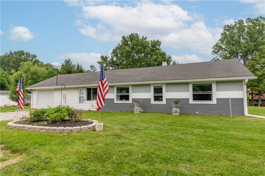 Welcome to this beautifully updated Ranch located in the City of Green!!  This well maintained 2-bedroom, 1-bath ranch home located in the desirable Green area in Summit County with access to top-rated schools, parks, shopping, airport, highway and restaurants along with other amenities. This home offers true one-floor living and sits on a sprawling .7981 acre lot with plenty of space for outdoor enjoyment, gardening, entertaining or future expansion.  The spacious living room is ideal for relaxation and entertaining, with built-in shelving and large windows for natural light.  Both bedrooms are bright and airy with Hunter ceiling fans and have been completely updated.  The kitchen combines charming style with practical space, offering ample cabinetry and hand made china cabinet, countertops and gas stove. The bathroom has been updated with a modern vanity, storage, lighting and stylish flooring.  Inside you find some thoughtful updates including, fresh paint in calming coastal tones, new Mohawk luxury vinyl plank flooring in bedrooms & living room, new Pella double hung windows, bedrooms have new trim, electric, drywall & doors,  living room has new trim, doors and electric, new hot water tank, new water softener, commercial grade spouting, updated electrical service with outside plug for portable generator hook up.   Step outside and enjoy the huge backyard oasis—featuring a large shed, patio, grilling area, garden beds, fire pit, and an abundance of mature trees for privacy and shade.  The oversized 1-car garage offers additional storage and even includes a workshop area to work on projects you may have.  This turnkey home offers comfort, functionality and pride of ownership inside and out. Whether you're a first-time buyer, downsizing, or looking for one-level living with land, this home delivers!