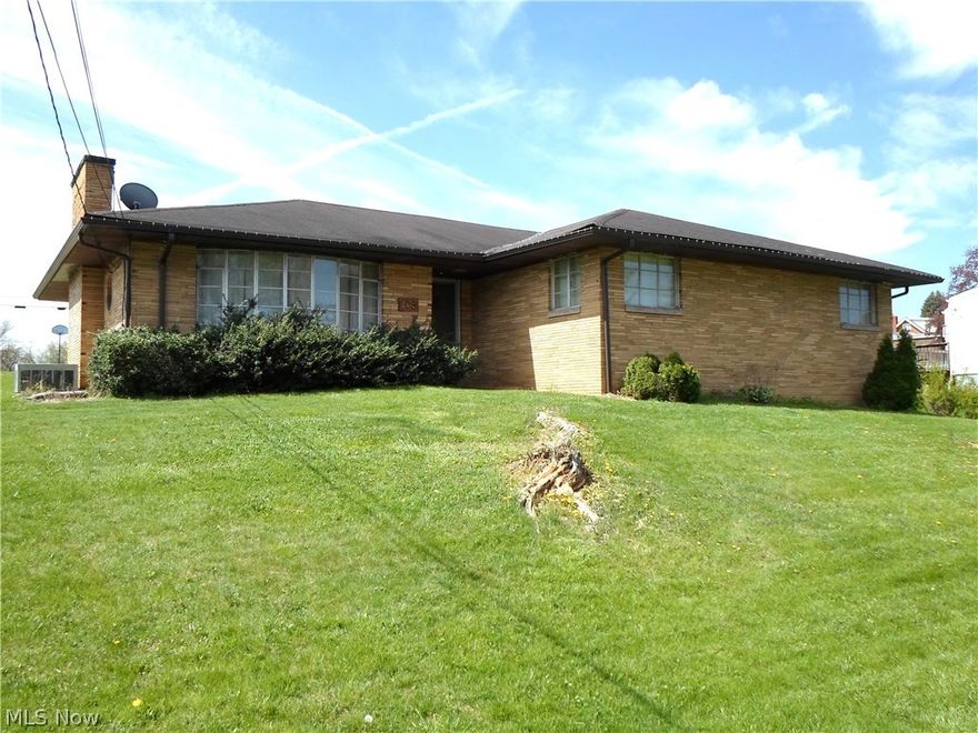 CLASSIC BRICK RANCH situated on an oversized corner lot in Follansbee on Hooverson Heights.  Offers 3 bedrooms, spacious living room and eat-in kitchen.  Breezeway leading to an attached garage and central air.