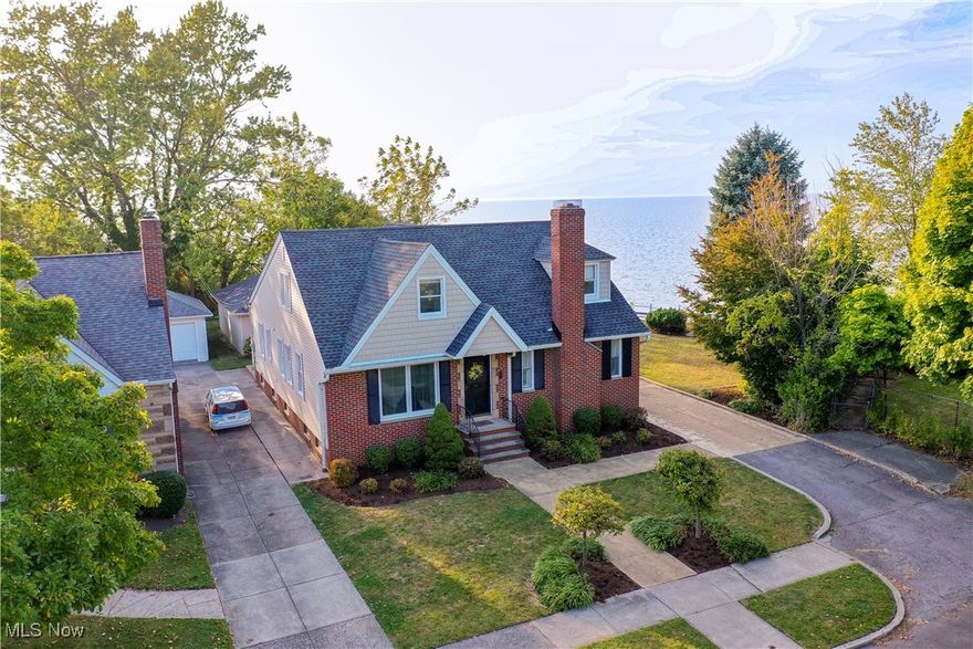 Experience the serenity of lakefront living in this stunning home, where Lake Erie breezes and dramatic sunsets create an enchanting atmosphere. Nestled on a peaceful dead-end street, with approximately 2,800-square-foot this home sits on an oversized double lakefront lot, offering breathtaking views from nearly every room. Perfect for both relaxation and entertaining, this property is truly a hidden gem. Step into the bright and airy foyer, leading you into expansive living and dining rooms that frame picturesque views of the lake. The eat-in kitchen is both functional and stylish, featuring ample cabinetry, granite countertops, and stainless-steel appliances—all while offering sweeping lake views that make cooking a joy. The first-floor owner's suite is a peaceful retreat with a private half bath, a changing room, and walk-in closets. Additional main-floor amenities include a private office or den, a full bathroom featuring a convenient in-suite laundry station, and a rear mudroom for added convenience. Upstairs, you'll find three spacious bedrooms, a full bath, and even a potential kitchenette, most boasting captivating lake views. The tandem bedrooms provide flexible living options to suit your needs. The lower level offers a blank canvas with a recreation room and plenty of storage space, ready for your personal touch. Outside, your lakefront oasis awaits. Enjoy relaxing on the rear deck or in the expansive yard, all while overlooking the natural beauty of Lake Erie. This home features a private stairway that leads directly to the lake, offering easy access to the breathtaking views. A detached three-car garage adds practicality to this charming retreat. This lakefront home is more than just a residence; it's a sanctuary where every day feels like a vacation. Don’t miss the opportunity to make this lifestyle yours.