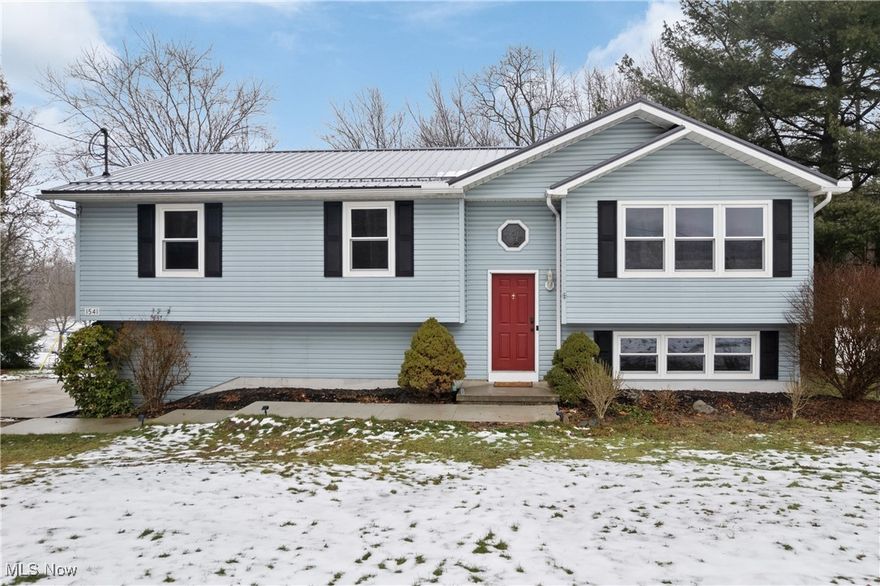 Welcome home to 1541 Eastern Road, where space, privacy, and modern updates come together on nearly 1.5 scenic acres in the Wadsworth School District! This 3 bedroom, 2 1/2 bath bi-level home features a bright, open layout with updated LVT flooring (2023) and a functional kitchen with breakfast bar and included appliances. Three generously sized bedrooms include the primary with an en suite bath with a tiled shower. The finished walk-out lower level adds flexible living space for a rec room, home office, or cozy retreat. Step outside to a fenced backyard with wooded views, deck, and shed—your own quiet escape just minutes from town. Thoughtful upgrades including a metal roof and gutters (2022), new windows (2022), reverse osmosis system (2020) and new concrete driveway and walkway (2024) provide peace of mind!