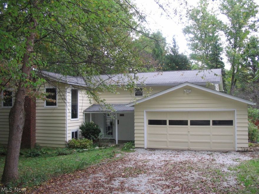 Yes, you can have it ALL!  Secluded bi-level home on 3/4 Acres of Privacy!  This home is perfect for Entertaining or Nestle in your own Private Setting with this Five Bedroom, 2 full Bath Home featuring an Open Floor Plan.  Great Room and Recreation Rooms have Wood Burning Fireplaces.  Some Hardwood Floors, Kitchen Appliances and Washer & Dryer come with this Neutral Freshly Painted Home.  Huge deck and 2 Car Attached Garage.  Sold AS IS.