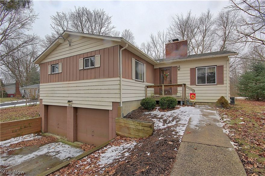 Nice ranch on large lot with 3 bedrooms and 2 full baths.  Two car attached garage leads you into family room on lower level.  The main level features beautiful hardwood floors throughout living area and bedrooms.  Master bedroom includes master bath and 2 his and her closets.  2 additional bedrooms and full bath on main level.  Patio slider off of large living area with wood burning fire place and pass through to kitchen. Additional updates include new roof (2017) and chimney.  Come see all this home has to offer!